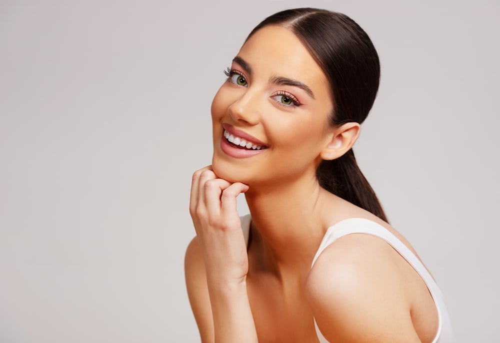 Woman with bright smile after cosmetic dentistry treatment in Herrin, IL